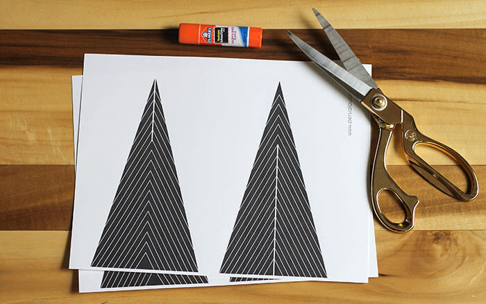 black and white modern christmas tree printables on a wooden table