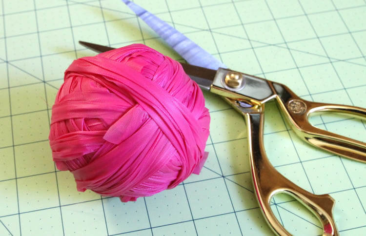 crochet an easter basket out of plastic yarn! Make your own colorful plastic yarn from old party tablecloths