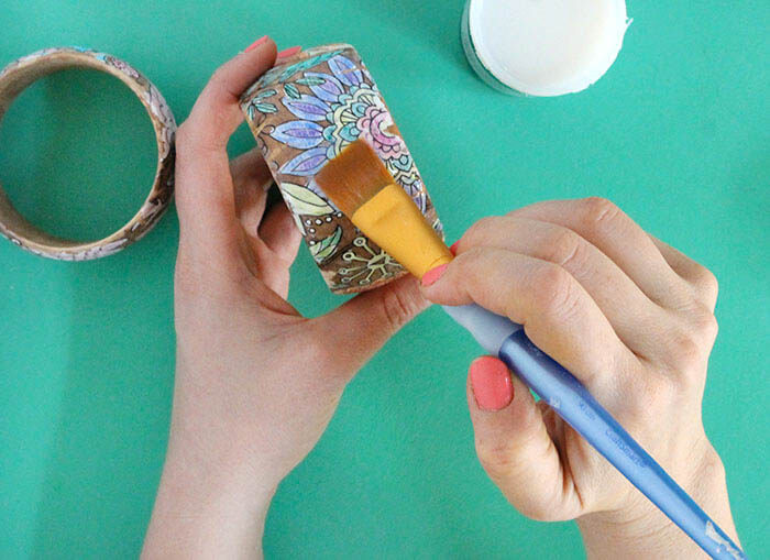 Make your own DIY coloring page bracelets. Turn your coloring book or your kids' artwork into a piece of jewelry! Perfect DIY Mother's Day Bracelets!