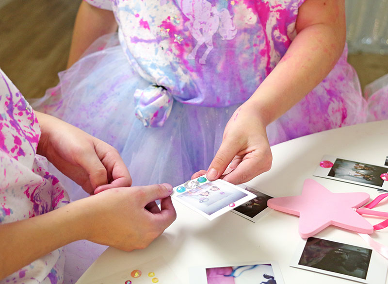 decorating photos at unicorn party