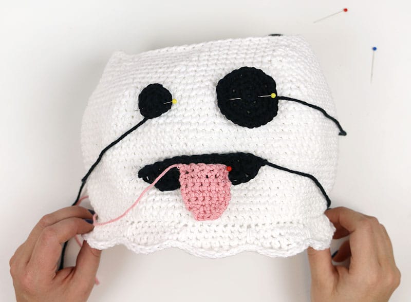 position ghost face pieces on crochet ghost bag