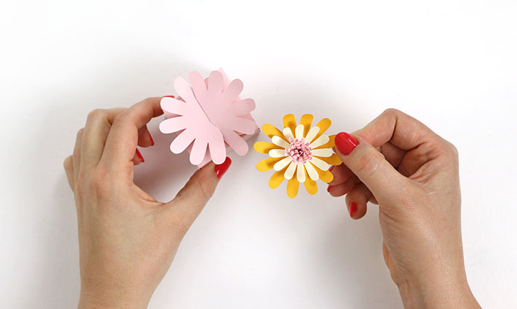 putting layered paper flower on top of finished box