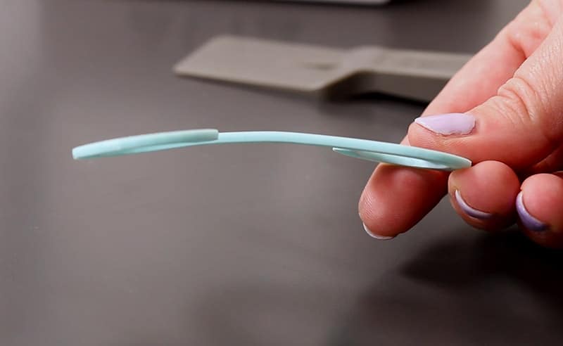 hand holding curved 3d printed ear saver