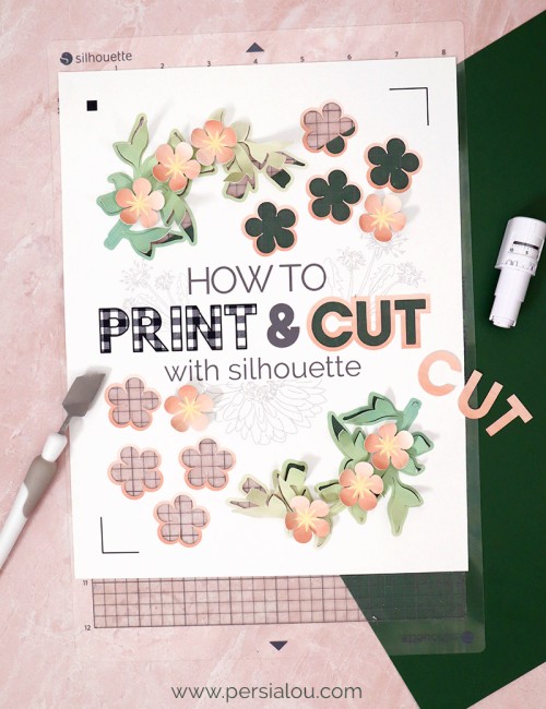 white cardstock on silhouette cutting mat with words printed and cut out of the cardstock reading how to print & cut with silhouette paper flowers and other craft supplies surround the cutting mat
