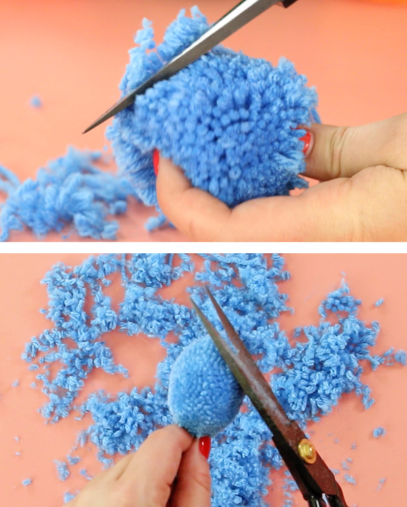 scissors trimming blue pom pom into oval shape