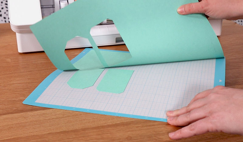 Peeling cut cardstock off of Silhouette cutting mat.