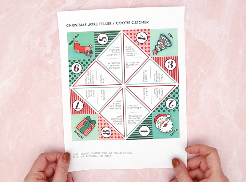 Christmas cootie catcher printable on light pink background