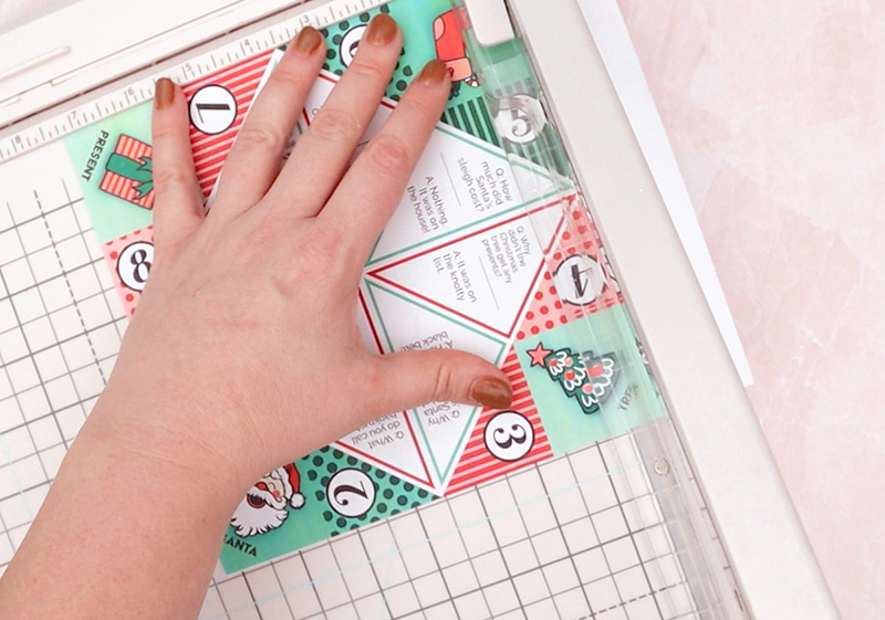 trimming edges of printable cootie catcher off with paper trimmer
