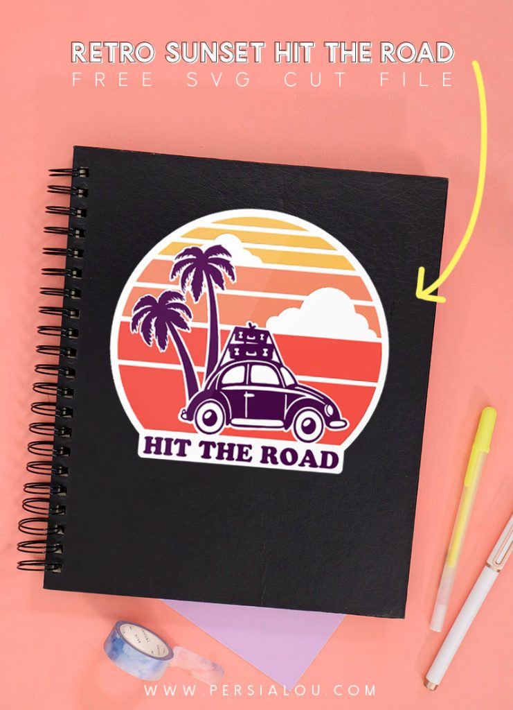 Black notebook with vinyl decal featuring a retro sunset design, a VW bug, and palm trees. The decal reads, 'hit the road.'