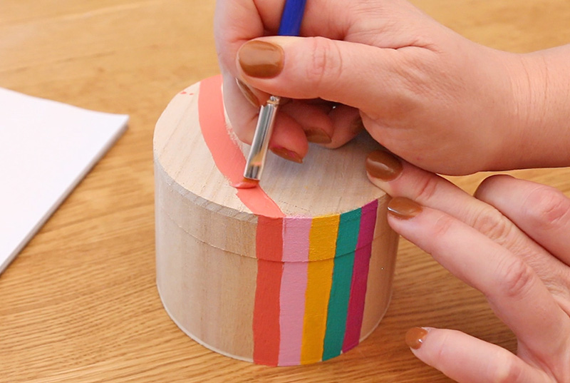 Paint coral rainbow stripe on top of the box.