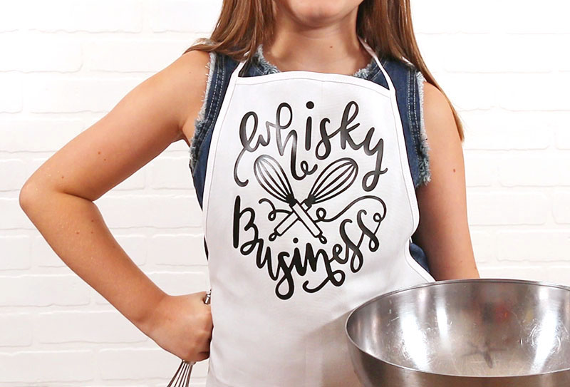 Girl wearing whisky business apron and holding metal bowl