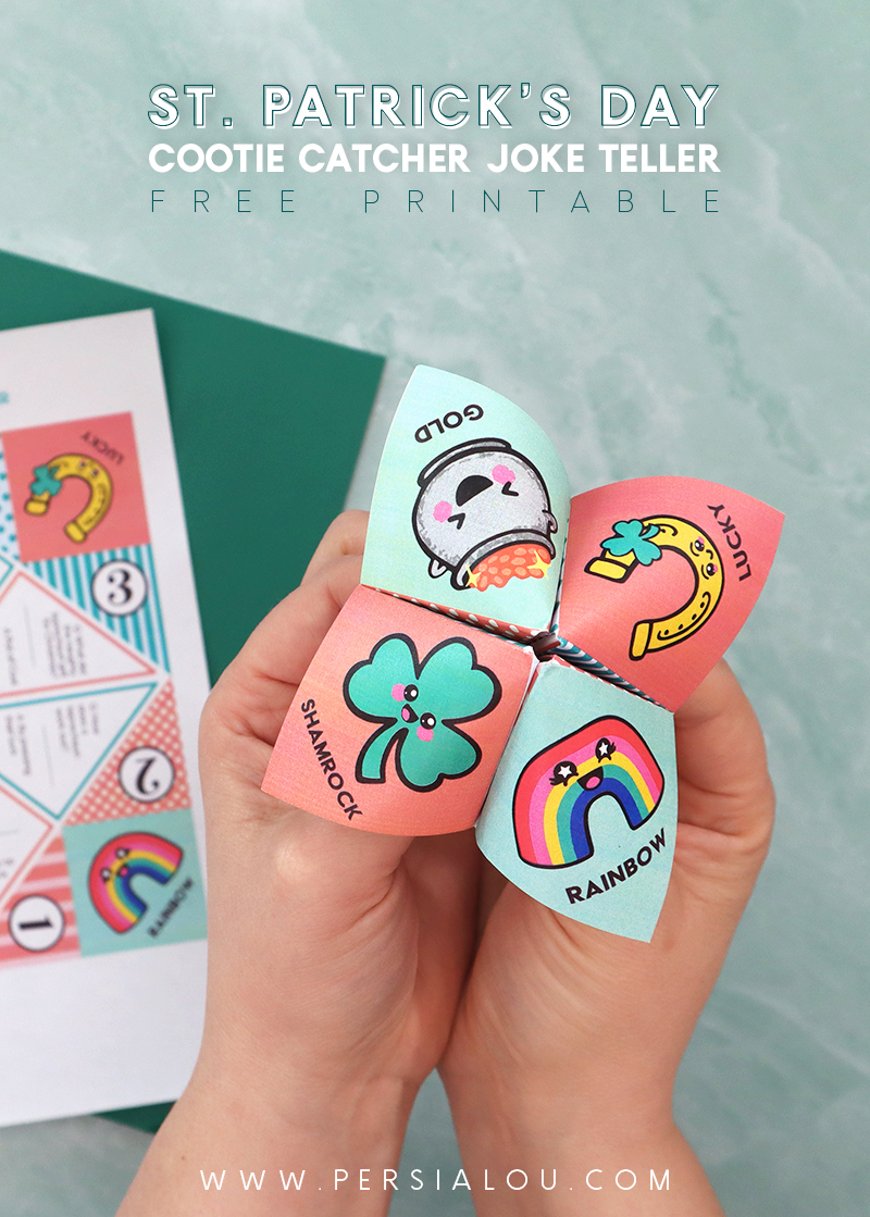 Two hands holding a folded paper joke teller / cootie catcher with St. Patrick's Day themed illustrations on the top.