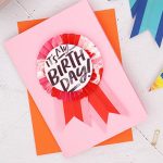 pink and red paper birthday rosette button that reads it's my birthday
