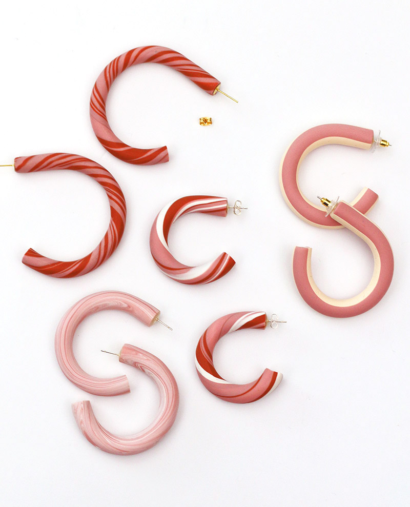 handmade pink clay hoop earrings lay on white background