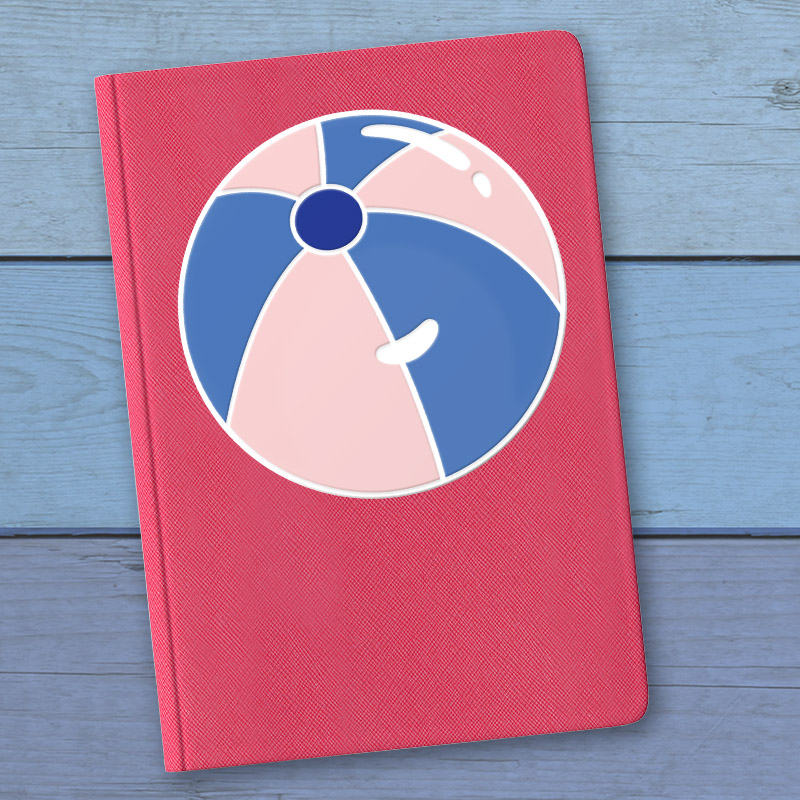 red notebook with pink and blue beach ball vinyl decal on the front