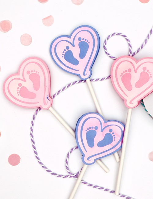 paper heart shaped cupcake toppers with baby feet design made with free baby feet svg cut file