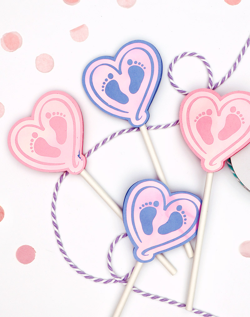 paper heart shaped cupcake toppers with baby feet design made with free baby feet svg cut file