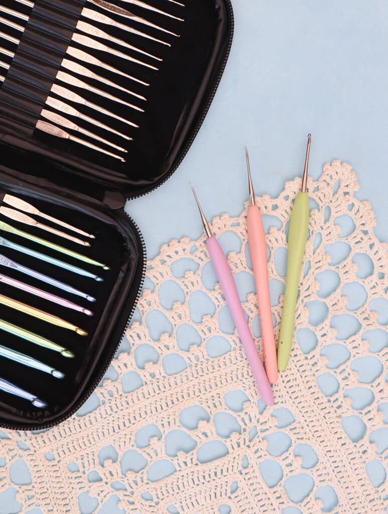 steel crochet hooks on crocheted doily